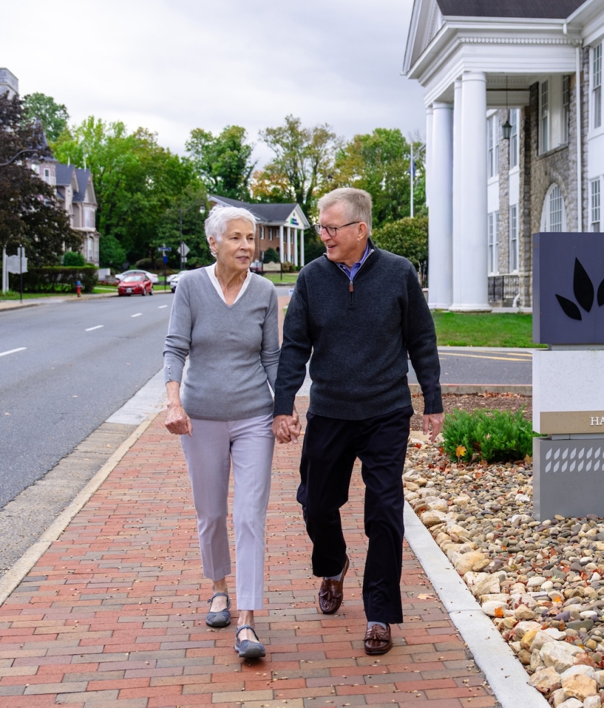 people walking down sidewalk
