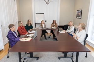 TCF leadership sits at a conference table during a meeting